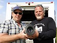 Wes Shaw, left, and Jeff Langford in 2019 with the projector for their drive in.