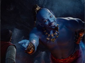 This image released by Disney shows Mena Massoud as Aladdin, left, and Will Smith as Genie in Disney's live-action adaptation of the 1992 animated classic Aladdin. (Disney via AP)