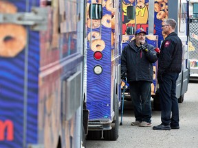 Mini Donuts food truck owner Barry Holmes talks with City of Airdrie fire inspector David Erb during a food truck inspection blitz in Calgary on Tuesday May 7, 2019.