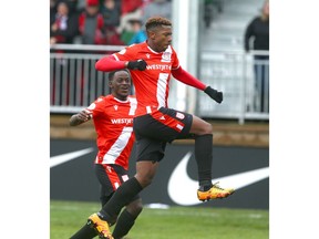 Dominique Malonga (R) jumps in the air and celebrates his second goal of the game with teammate Nathan Mavila (L) during Canadian Premier League soccer action between Cavalry FC and Halifax Wanderers FC at ATCO Field at Spruce Meadows in Calgary on Saturday. Cavalry won 2-0 and remain undefeated. Photo by Jim Wells/Postmedia.