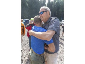 John Eller, right, hugs rescue lead Javier Cantellops at the Makawao Forest Reserve base camp on Saturday, May 25, 2019 in Wailuku, Maui. The Maui News reported Friday Amanda Eller was found injured in the Makawao Forest Reserve. Family spokeswoman Sarah Haynes confirmed she spoke with Eller's father John. Eller was airlifted to safety.