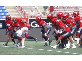 Calgary Stampeders RB. Job Reinhart takes on the defensive line as the Stamps held their mock game at McMahon stadium in Calgary on Sunday, May 26, 2019. Darren Makowichuk/Postmedia