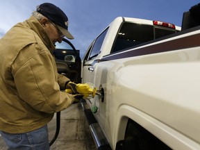 Lloydminster resident Ron Noble fills up his truck and his auxiliary tank at a Co-op Cardlock station on the Alberta side of the border in Lloydminster, Alberta on Thursday, December 22, 2016.