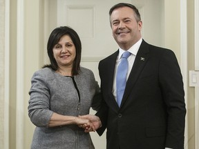 Alberta Premier Jason Kenney shakes hands with Adriana LaGrange after she was sworn in as Minister of Education on April 30, 2019.