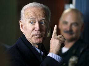 In this May 13, 2019, photo, former vice president and Democratic presidential candidate Joe Biden interacts with a supporter during a campaign stop at the Community Oven restaurant in Hampton, N.H.