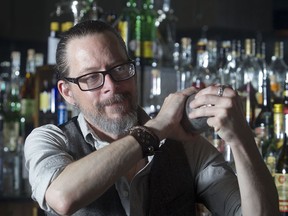 Nathan Head, co-owner of Milk Tiger Lounge, shakes up a Champs Elysees cocktail.