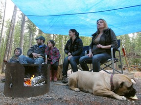 Campers take shelter at Maclean Creek during a rainy May long weekend in 2014. From left: Ashton Dafoe, Philip Dafoe, Mikayla Robinson, Sandra Robinson and friend Angelica Hizsa with their dog Whiskey.