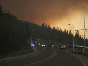 Residents of the subdivision of Abasand wait in their cars to leave the subdivision in Fort McMurray Alta. on Tuesday May 3, 2016. The subdivision had been placed under a mandatory evacuation Tuesday afternoon with wildfires threatening the region.