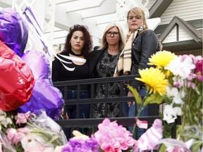 From left, Racha El-Dib, whose sister Nadia was killed last year, Kim Ruse, Executive Director of the Calgary WomenÕs Emergency Shelter and Dana Burrows, GoFundMe organizer for the Lovett family reflect upon the recent murder Jasmine Lovett and her 22-month-old daughter Aliyah Sanderson. This memorial set-up in the Cranston townhouses where Lovett lived has been growing since their bodies were discovered on Monday. Friday, May 10, 2019. Brendan Miller/Postmedia