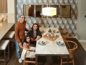 Zainab Jafri, 7, sits with her parents Fatima Zehra and Yasir Jafri in a Carrington showhome, in Calgary on May 19,  2019. They are excited to move into their new home.