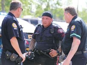 A Calgary police officer is tended to by EMS following a confrontation with a number of individuals at the Southwood Community Assoc skatepark in Calgary on Saturday, June 1, 2019.