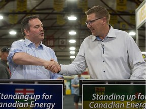 Saskatchewan Premier Scott Moe, right, shakes hands with Alberta Premier Jason Kenney during the Saskatchewan Oil & Gas Show held at the Crescent Pointe Centre in Weyburn.