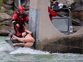 Calgary firefighters take part in Bow River water rescue training placing a trapped dummy on a bridge support in Edworthy Park on Thursday, June 20, 2019. Due to the high streamflow advisories, the City of Calgary is advising Calgarians against boating and all other watercraft activities on the Elbow and Bow Rivers.