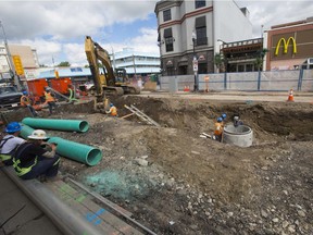 Construction workers prepare for the weekend closure of the busy intersection of 14th Street and 17th Avenue S.W. on Tuesday, June 25, 2019.