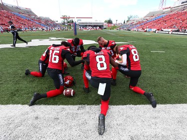 Calgary Stampeders' players pray before CFL action between the Ottawa Redblacks and the Calgary Stampeders in Calgary on Saturday, June 15, 2019. Jim Wells/Postmedia