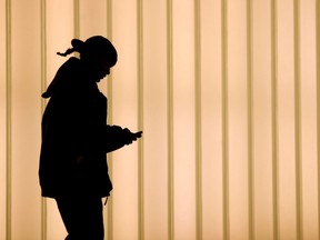 In this file photo taken on November 12, 2010, a woman walks inside of the World Trade Center while using a cell phone in New York.