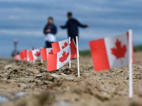 This illustration picture taken on June 4, 2019 shows Canadian flags planted in the sand of Juno Beach in Courseulles-sur-Mer, western France, during the preparations of the celebrations marking the 75th anniversary of D-Day landings.