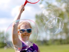 Mariah McKenzie,8, has some fun making bubbles after she took part in Betty's Run for ALS at North Glenmore Park which celebrates, promotes and channels hope for those affected with ALS, their families and their friends. Over the past 23 years, Betty's Run has raised over $7 million due to the generous support of donors and participants in Calgary on Sunday, June 9, 2019. Darren Makowichuk/Postmedia