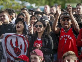 Toronto Raptors fans cheer as they watch game five of the NBA finals at an outdoor viewing party in Calgary, Alta., Monday, June 10, 2019.THE CANADIAN PRESS/Jeff McIntosh