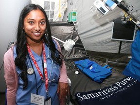 Sharla Boody, a registered nurse with the non-profit organization Samaritan's Purse, shows the inner workings of an emergency field hospital during a dedication ceremony for the organization's new warehouse facility.