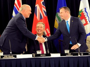 Jason Kenney, Premier of Alberta, shakes hands with John Horgan, Premier of British Columbia, at the closing of the Premiers' Conference in Edmonton, Alberta, Canada, June 27, 2019.   REUTERS/Candace Elliott ORG XMIT: GGG-EMT220