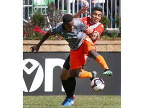 Forge FC Kwame Awuah (front) fights off Cavalry FC Jose Escalate during CPL action between Forge FC in Calgary at ATCO Field at Spruce Meadows on Saturday, June 22, 2019. Jim Wells/Postmedia