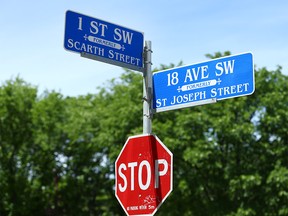 A street and sttop sign at 18 Ave and 1 St SW in Calgary is shown on  Wednesday, June 12, 2019. A group is proposiing to make a small number of stop signs bilingual and it will be privately funded. Jim Wells/Postmedia