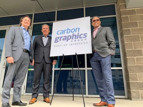 Tim Flaman, Tony Militano and Tony Smith with new logo for Carbon Graphics Group.