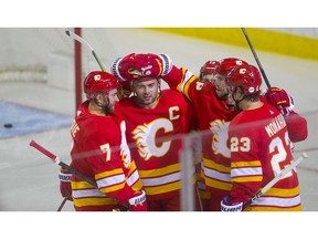 Calgary Flames Mark Giordano celebrates his goal with teammates against the Vancouver Canucks in NHL hockey action at the Scotiabank Saddledome in Calgary,  on Saturday October 6, 2018. Leah Hennel/Postmedia