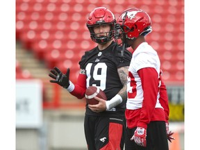 Calgary Stampeders QB Bo Levi Mitchell talks to receiver Josh Huff earlier in training camp. File photo by Jim Wells/Postmedia.