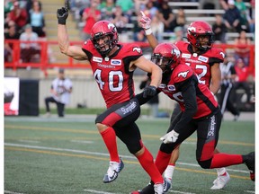 Calgary Stampeders' Nate Holley celebrates with fellow defensive team members after a turnover during pre-season CFL action against the Saskatchewan Roughriders at McMahon Stadium in Calgary on Friday May 31, 2019.
