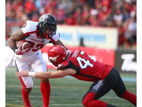 Ottawa Mossis Madu (L) is tackled by Stampeders Fraser Sopik during CFL action between the Ottawa Redblacks and the Calgary Stampeders in Calgary on Saturday, June 15, 2019. Jim Wells/Postmedia