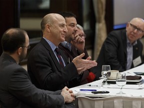 University of Calgary professor Bev Dahlby (second from left) answers an audience member's question at the Chateau Lacombe in Edmonton, Alberta on Wednesday, Feb. 21, 2018. Photo by Ian Kucerak / Postmedia