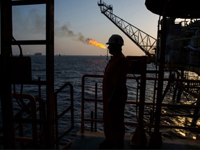 A gas flame burns from a pipe close to an offshore oil platform in the Persian Gulf's Salman Oil Field, operated by the National Iranian Offshore Oil Co., near Lavan island, Iran.