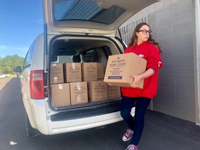 Chloe Thomas, 12, delivers boxes filled with 5,000 meals being donated from her school, Airdrie Koinonia Christian School, to Hope Mission in Calgary on June 10, 2019. The donation will be enough to feed children in the community for a month.