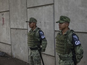 National Guard soldiers stand at a checkpoint in Tapachula, Chiapas state, Mexico, on Wednesday, June 19, 2019. The new show of force on the border is meant to stem the stream of migrants escaping violence and poverty in Central America, a move made to appease President Donald Trump after he threatened to impose tariffs on Mexican imports to punish the country for failing to control the masses trying to make their way to the U.S. Photographer: Alejandro Cegarra/Bloomberg ORG XMIT: 775360146