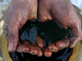 An employee holds a sample of crude oil at the Yarakta oilfield in Russia.