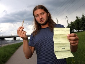 Philip Karlinsky was walking along a paved pathway to the Shawnessy CTrain Station last Thursday afternoon, smoking a joint when two bicycle-mounted police officers stopped him and issued a $100 ticket for smoking in a prohibited area despite Karlinsky's protests that included showing the pair his medical cannabis permit and the city's bylaw allowing him to consume in most outdoor places in Calgary on Monday, June 17, 2019. Darren Makowichuk/Postmedia