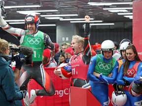 Sam Edney (L) and Alex Gough of Canada celebrates after their performance in the luge team relay competition during the 2018 Winter Olympics in Korea, February 15, 2018. Photo by Jean Levac/Postmedia