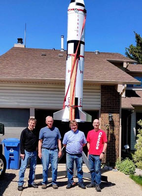 Left to right: Ian Stephens, John Glasswick, David Buhler and Shane Weatherill pose in front of their scale model of a Saturn V rocket in Beddington recently.