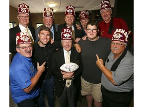 (L-R) Calgary Dino's, Zachary Newman and Daniel Stefanyk pose with Al Azhar Shriners Potentate, Ernie Hilland and other Shriners at Spolumbo's in Calgary as the two will travel to Montana to participate in an East-West Shrine Bowl football game with all proceeds of the game to benefit the Shriners Children's Hospital on Thursday June 14, 2018. Darren Makowichuk/Postmedia