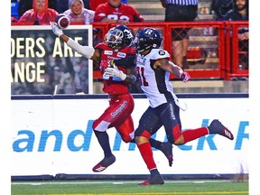 The Calgary Stampeders' Don Jackson reaches for the ball while being harassed by the Ottawa Redblacks' Kevin Brown during CFL action at McMahon Stadium in Calgary on Thursday June 28, 2018. Gavin Young/Postmedia