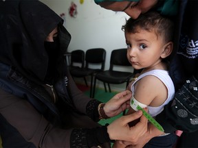 A pediatrician measures a displaced Syrian refugee child at a mobile clinic, in north Azaz, Syria June 13, 2019. Picture taken June 13, 2019. REUTERS/Khalil Ashaw’ ORG XMIT: HFS-GGG-SYR17