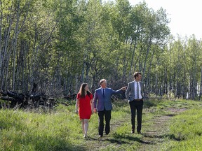 WestCreek Developments' Kalida Goldade, marketing manager; Bravin Goldade, president; and Jared Goldade, general manager; walk in the untouched land that will become The Woods in Legacy.