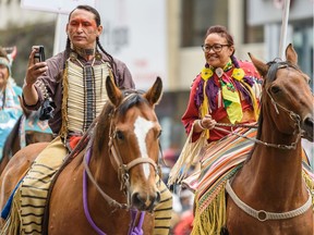 Members of Kainai First Nation take a selfie during the 2019 Calgary Stampede Parade.