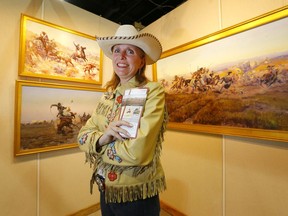 Jill Cross, a volunteer with the Western Showcase and Charlie Russell exhibit in the BMO Centre at Stampede Park in Calgary on Wednesday, July 3, 2019. Darren Makowichuk/Postmedia