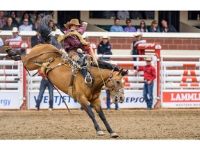 Dawson Hay from Wildwood, AB rides Sunset Strip to the first place during the Saddle Bronc Performance at Calgary Stampede Rode on Tuesday, July 9, 2019. Azin Ghaffari/Postmedia Calgary