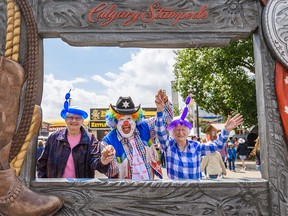 Truus Vandenbrink, left, Shane Farberman known as Doo Doo The Clown, and Joan Hutton at the Calgary Stampede on Tuesday, July 9, 2019.