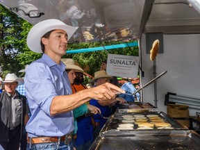 Prime Minister Justin Trudeau flips pancakes at a community Stampede Breakfast at Sunalta in Calgary on Saturday, July 13, 2019. Azin Ghaffari/Postmedia Calgary