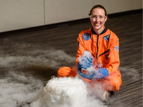 Nicole Courchesne, a facilitator at Telus Spark poses for a photo with a container of liquid nitrogen and water. Telus Spark will be hosting a special event on Saturday to celebrate the 50th anniversary of the Apollo 11 Moon landing.
